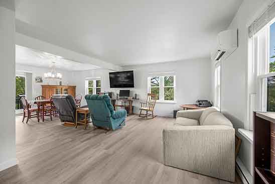 Spacious living and dining area at 1701 Harrington Road, Orange VA, with large windows, light wood flooring, and open layout filled with natural light..