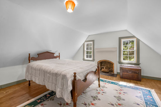 iew through original doorway at 3665 Old River Trail in Powhatan, Virginia, leading to upstairs rooms in the 18th-century portion of Pleasant Oak, featuring wide-plank floors, period millwork, and early American design.
