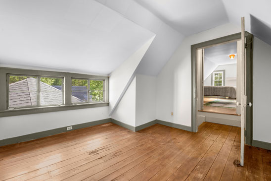 Second upstairs room at 3665 Old River Trail in Powhatan, Virginia, located in the 18th-century portion of Pleasant Oak. Features include original wood floors, dormer windows, and a view into the adjacent historic bedroom.
