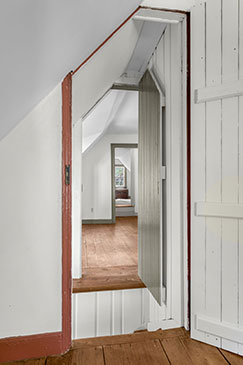 View through original doorway at 3665 Old River Trail in Powhatan, Virginia, leading to upstairs rooms in the 18th-century portion of Pleasant Oak, featuring wide-plank floors, period millwork, and early American design.
