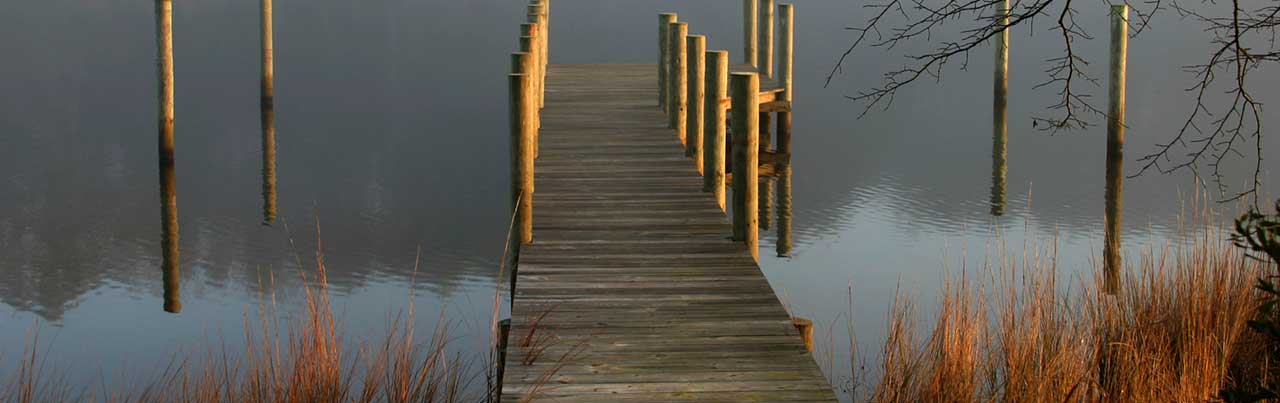 Central Virginia waterfront property with a private dock, still water, wooded shoreline, and peaceful country setting