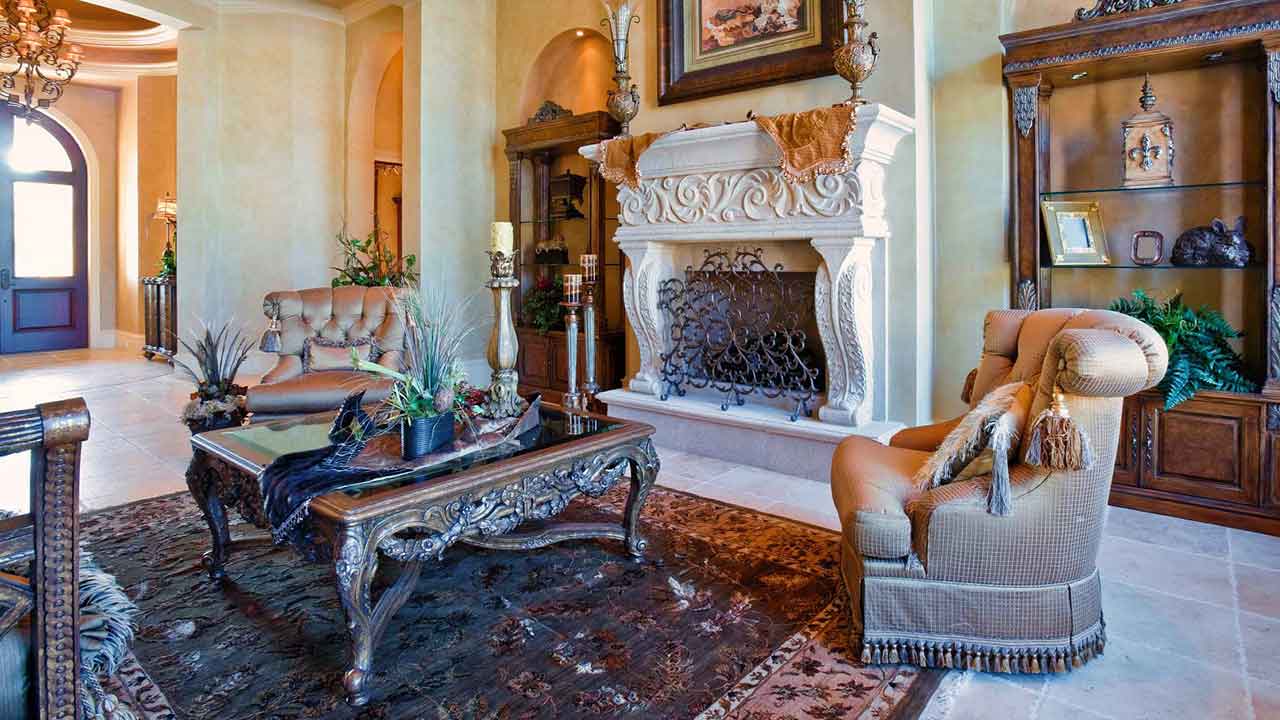 Elegant luxury estate living room in Charlottesville, VA featuring ornate carved fireplace, high ceilings, refined furnishings, and sophisticated architectural detailing.